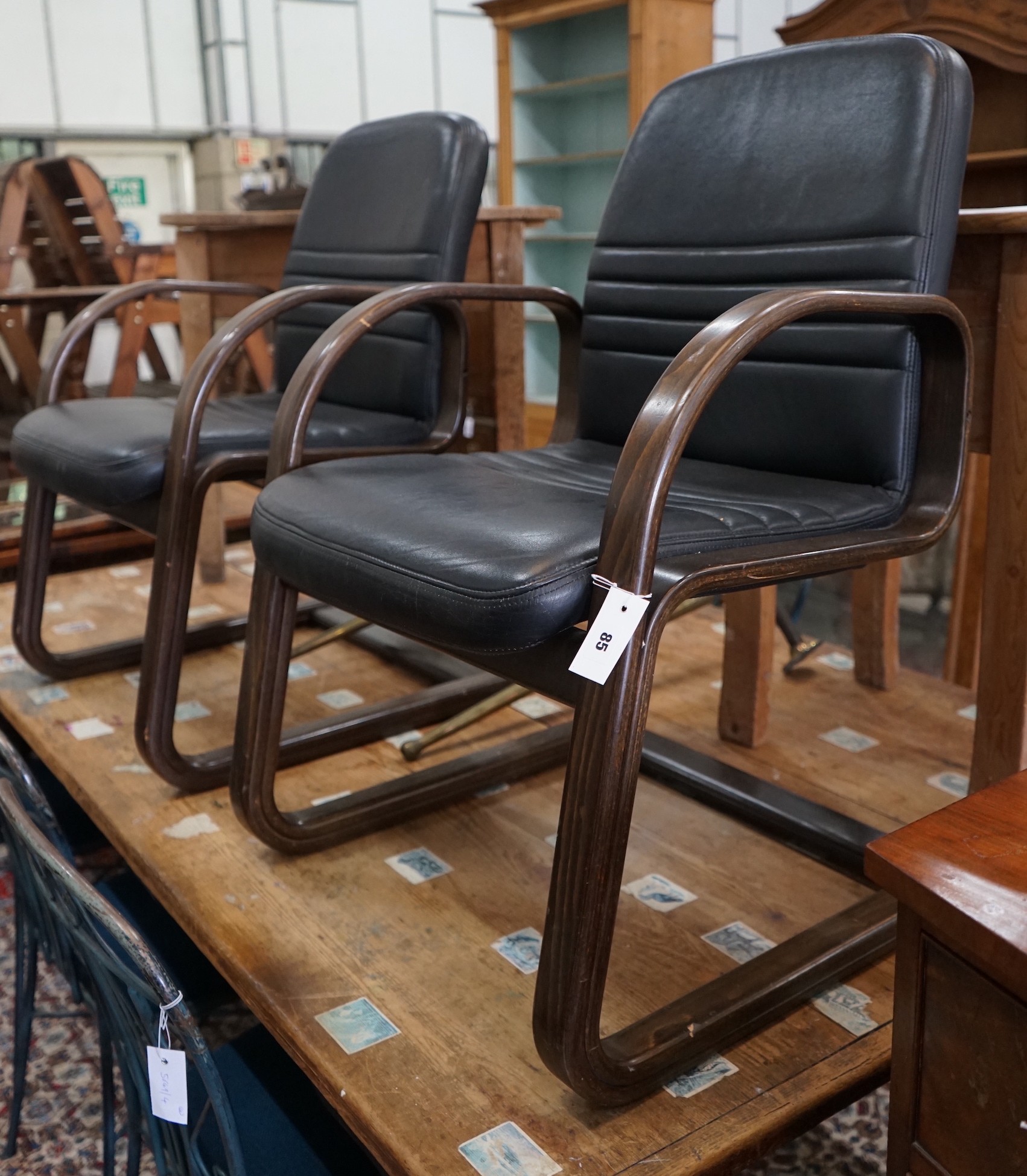 A pair of Sedus cantilever chairs, wood and black leather, width 60cm, depth 54cm, height 90cm
